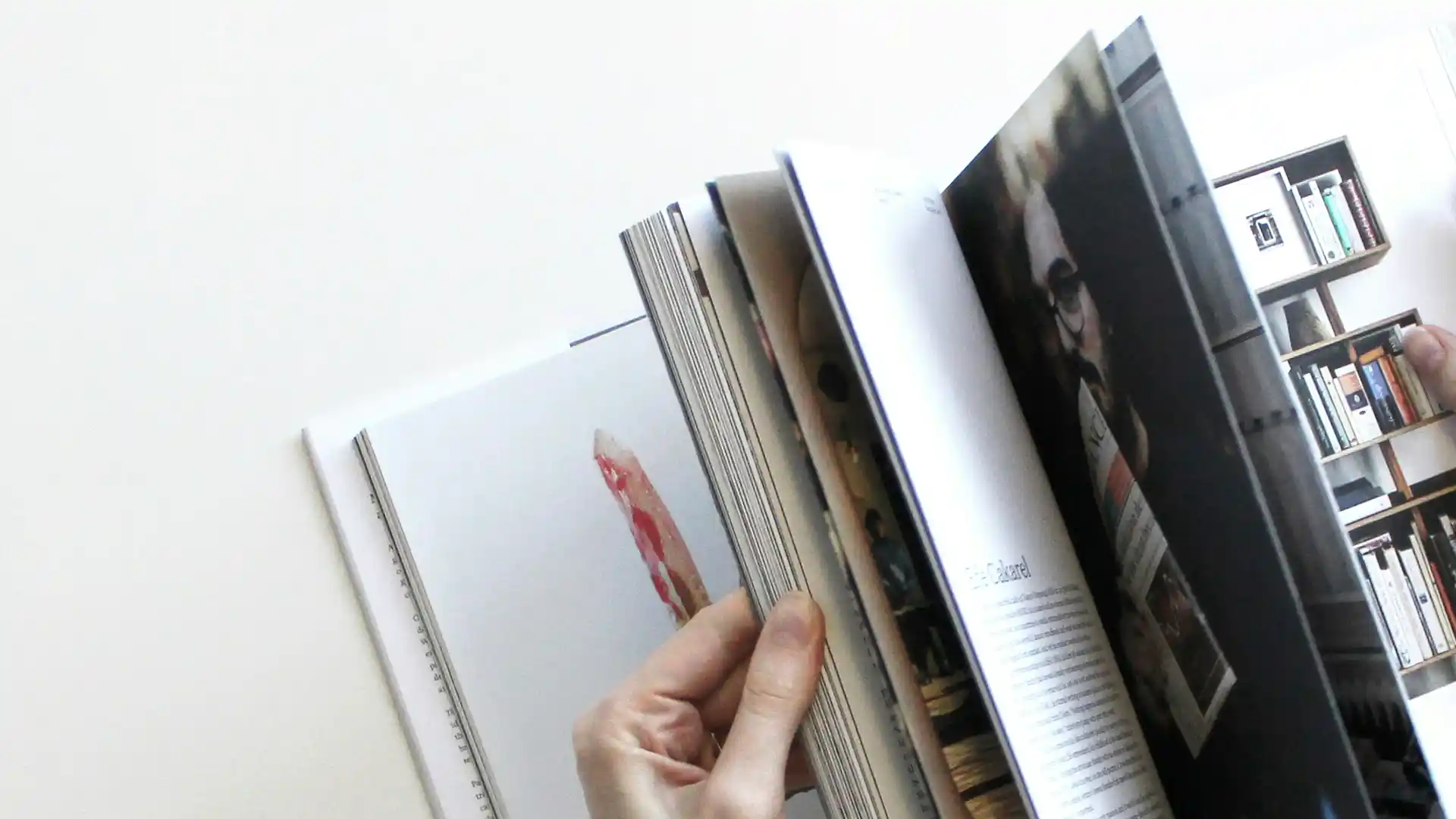 a magazine being flipped through by a pair of hands